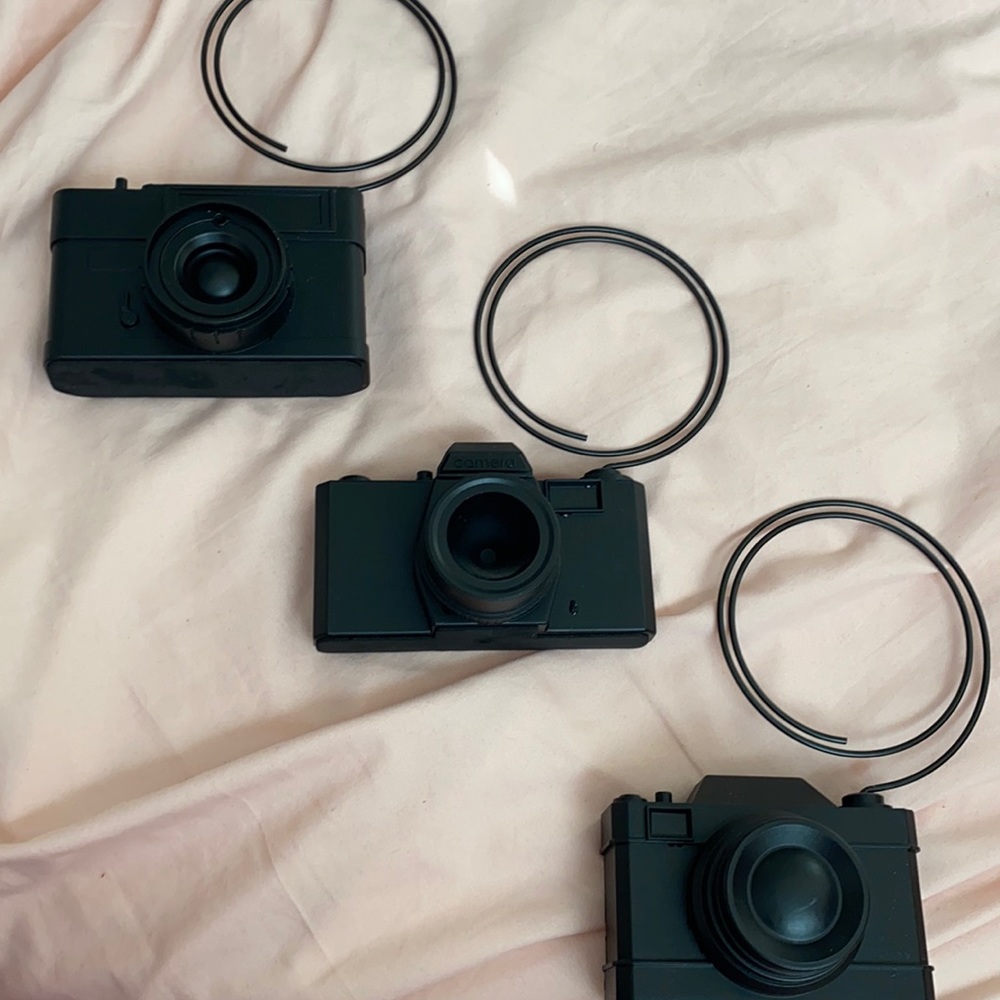 three black camera picture holders